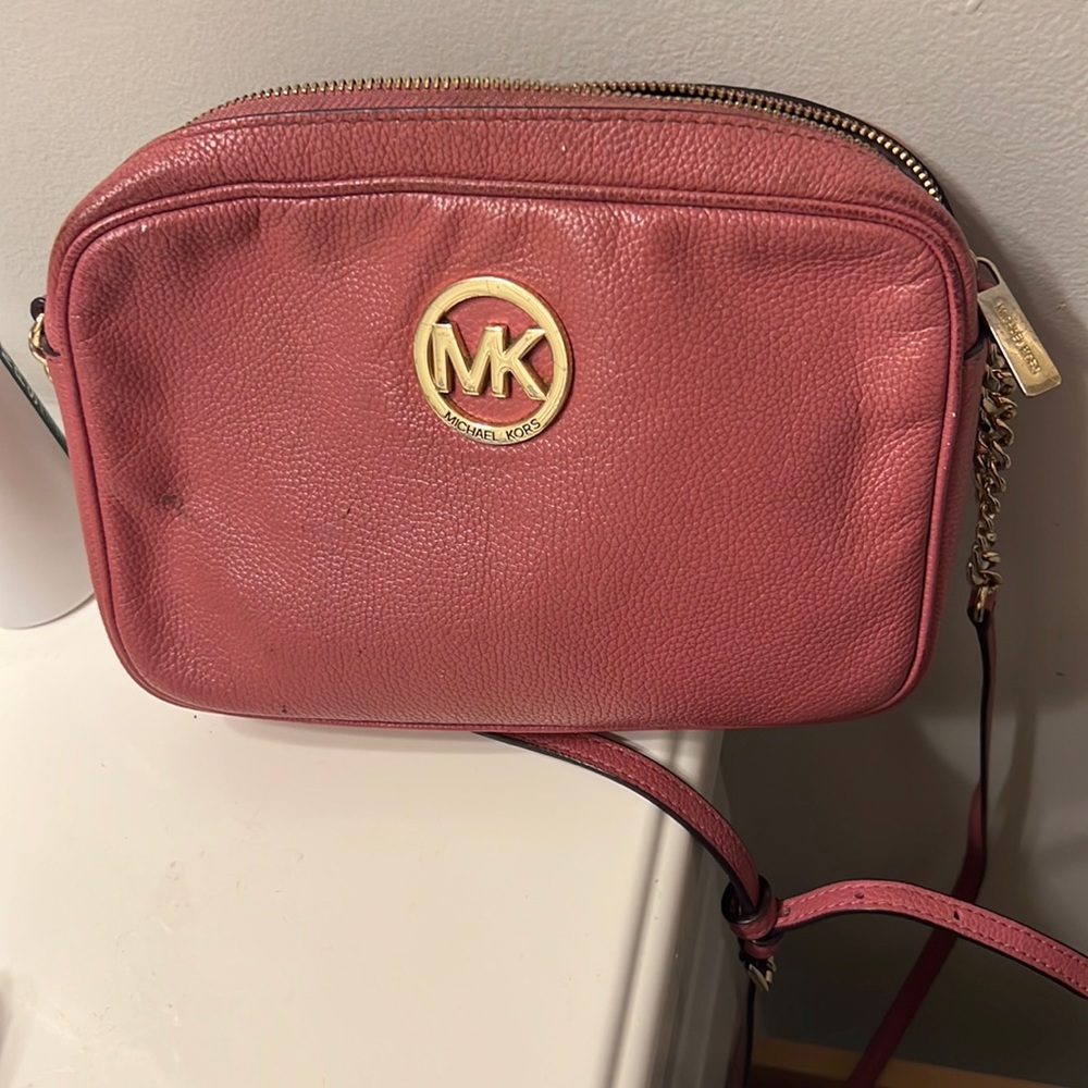 MK rose pink crossbody! Loved and used but has along way to go! Nice go to bag.